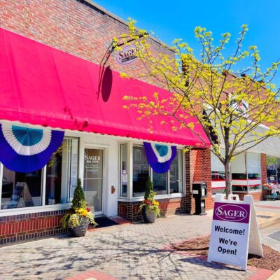 Sager Real Estate office in Strasburg, VA decorated with purple Mayfest buntings on a sunny late spring day.