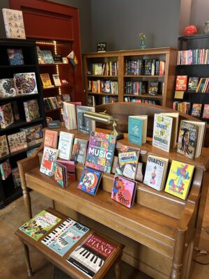 Books arranged on a display piano at Bonfire Bookstore in Woodstock, Virginia, a newly opened independent bookstore.